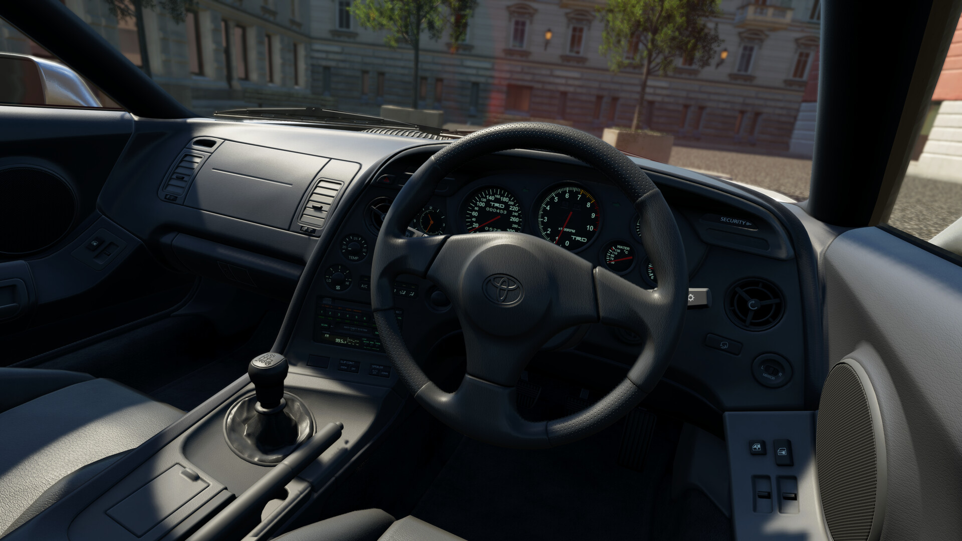 Close-up cockpit view inside Assetto Corsa EVO showing detailed dashboard rendering, steering wheel, and windshield reflections