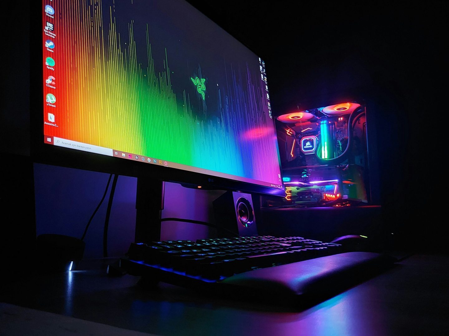 A split-image composition showing a glowing, high-end gaming PC build on the left and a massive hyperscale data center corridor on the right, with dollar signs or price tags floating between them. Dark, dramatic lighting. Tech-editorial style.